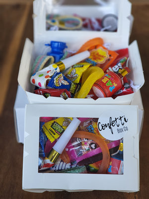 Vibrant kid's snack boxes brimming with an assortment of delicious snacks, candies, and lollies, perfect for indulging young appetites and sweet tooth cravings.
