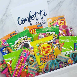 Variety of chocolates and confections in a Confetti Box Co gift box.
