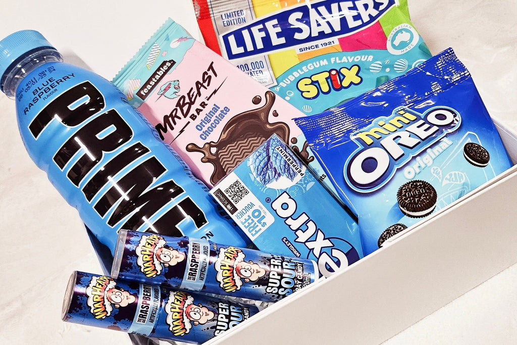 Prime Hamper: The perfect gift for any occasion, featuring 500ml Prime drink, Lifesaver Stix, Mr. Beast chocolate, Extra Chewies, Warhead sprays, and mini Oreo pack. All beautifully presented in a magnetic box with exclusive confetti and a bow for a delightful surprise.
