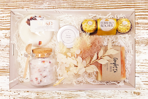 Soak and Relax Box 2: The ultimate relaxation gift featuring Lavender and Rose Bath Salts, a fun Donut Bath Bomb, Ferrero Rocher Chocolates, Coconut Milk Soap, Vanilla Lip Balm, and Dried Flowers. A perfect blend of soothing scents and indulgent treats for a serene experience.