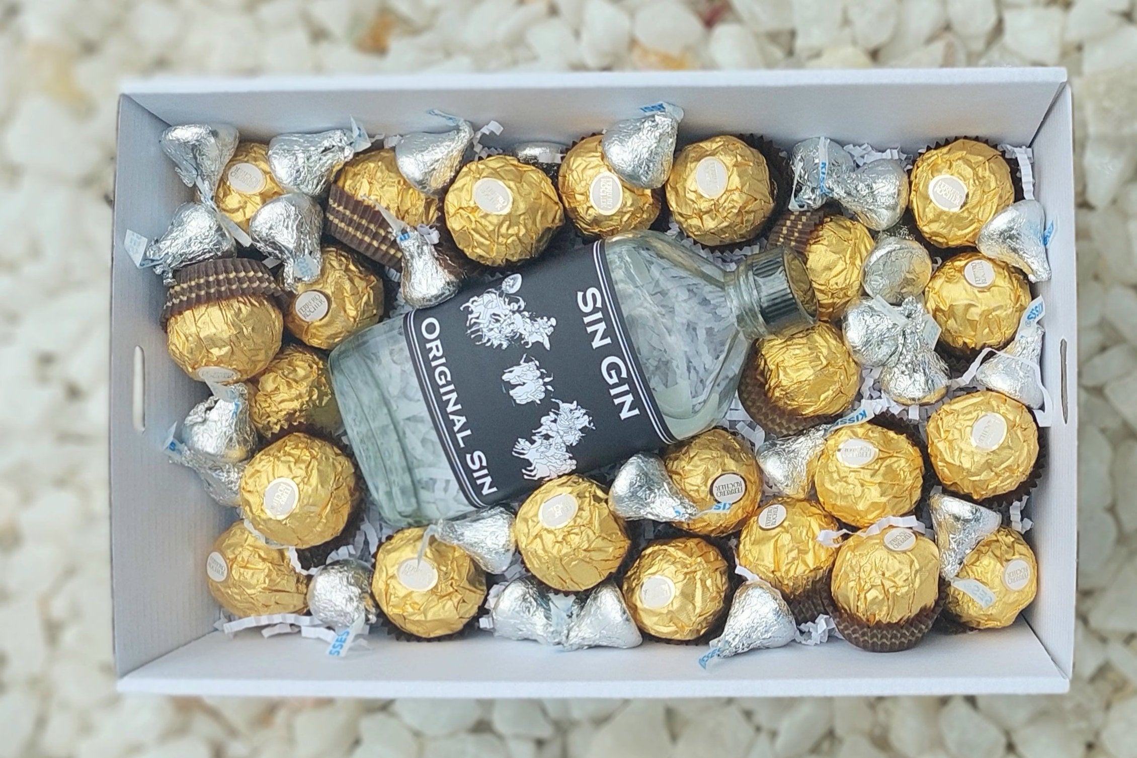 Chocolates & Spirits Gift Box: Celebrate someone special with a perfect pairing of 200ml Sin Gin Original Sin, 15 Ferrero Rocher chocolates, and Hershey's Kisses. Includes a complimentary personalized message for a thoughtful touch.