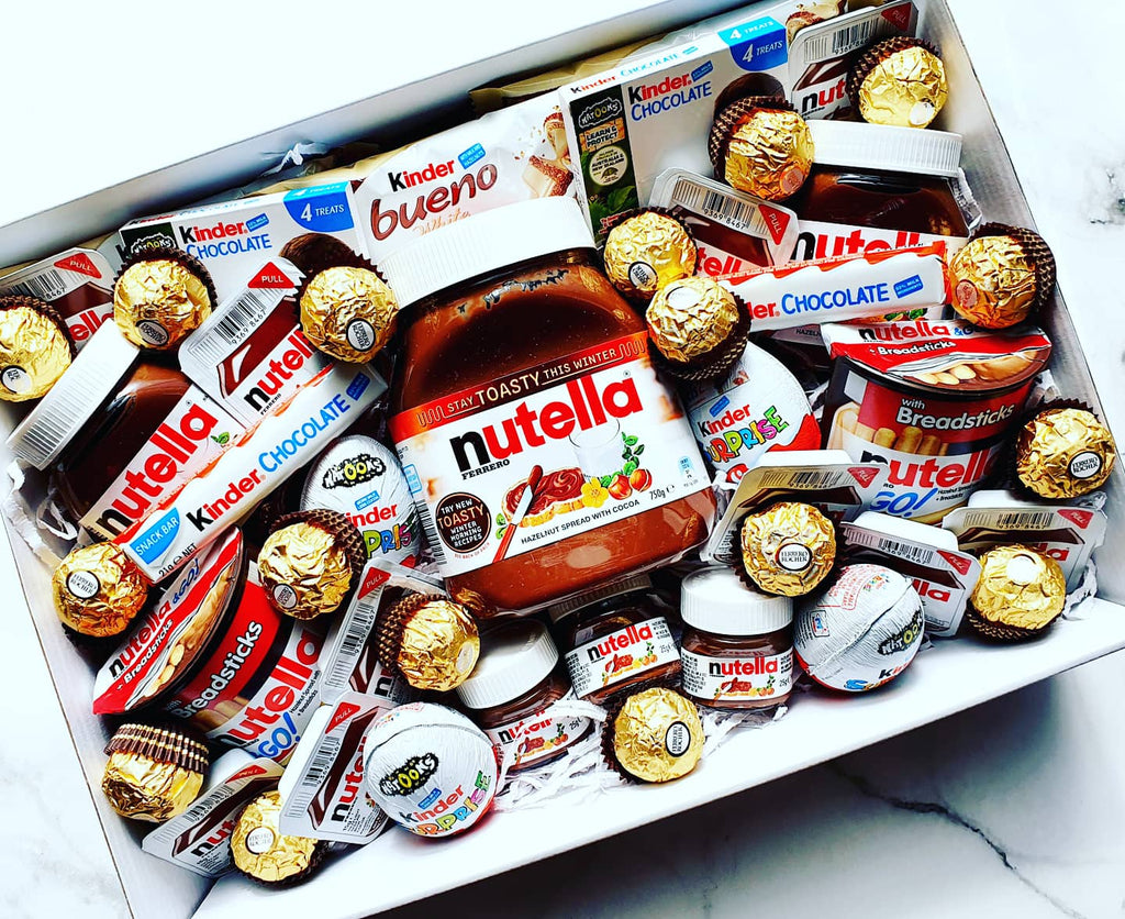 Embark on a Nutella lover's dream with our Nutella Ultimate Indulgence Package. This sumptuous collection includes a 750g Nutella jar, 2 Nutella Bueno bars, 2 220g Nutella jars, 2 mini jars or extra scoops, and 8 Nutella scoops for spreading joy on any treat. Dive into the sweetness with 2 Nutella 2 Go breadsticks, 4 Kinder Eggs, 2 Kinder Chocolates (21g), 2 Kinder bars (50g), and 15 Ferrero Rocher delights. It's a feast for the senses, perfect for gifting or satisfying your own cravings