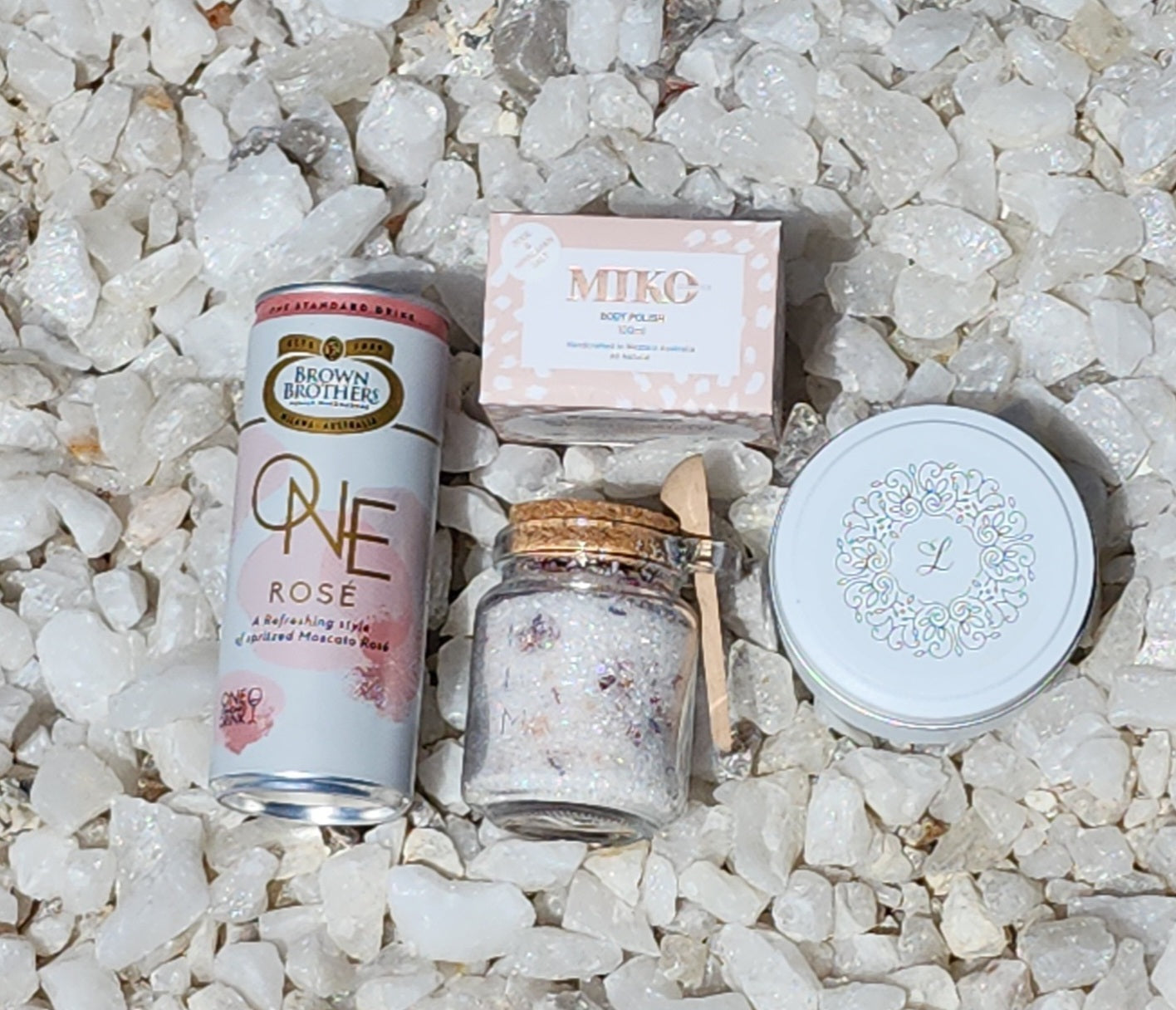 Personal Indulgence Gift Box: Perfect for relaxation with Brown Brothers One Moscato Rosé, bath salts, Lenx Natural Soy Candle (WA Made), Miko Cosmetics Body Polish (Rose & Himalayan Salt), and Hershey's Kisses. Finished with signature confetti for a blissful and luxurious experience.