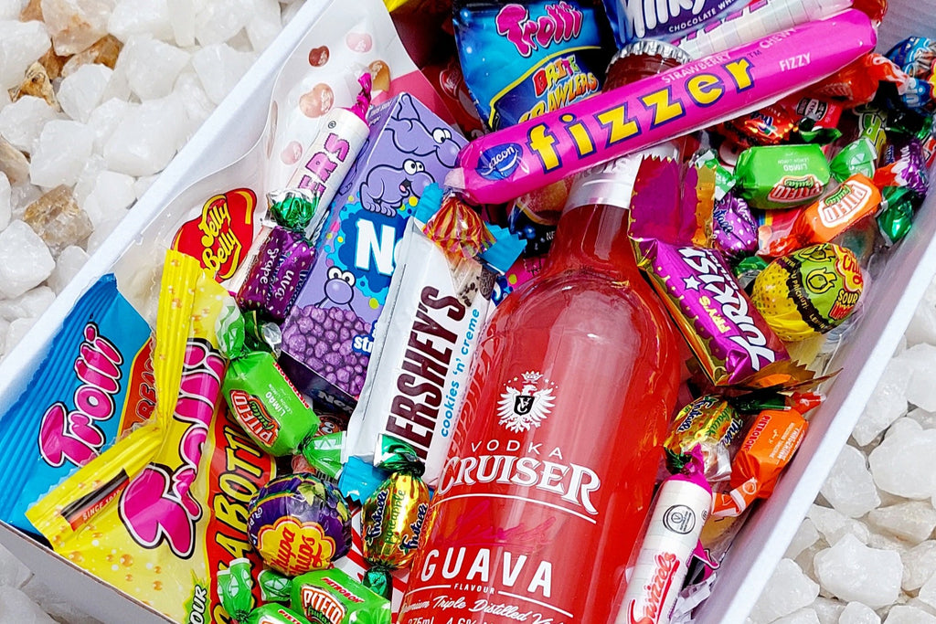 Vodka Cruiser & Sweet Treats Gift Box: Indulge in a mix of Vodka Cruiser and an assortment of sweet delights, including 5 Trolli bags, Chupa Chups Sour Bites, Jelly Belly pack, Fizzer, Mini Kit Kats, mini chocolates, Nerds, Skittles, and extra fizzers and lollies for the ultimate sugary indulgence.