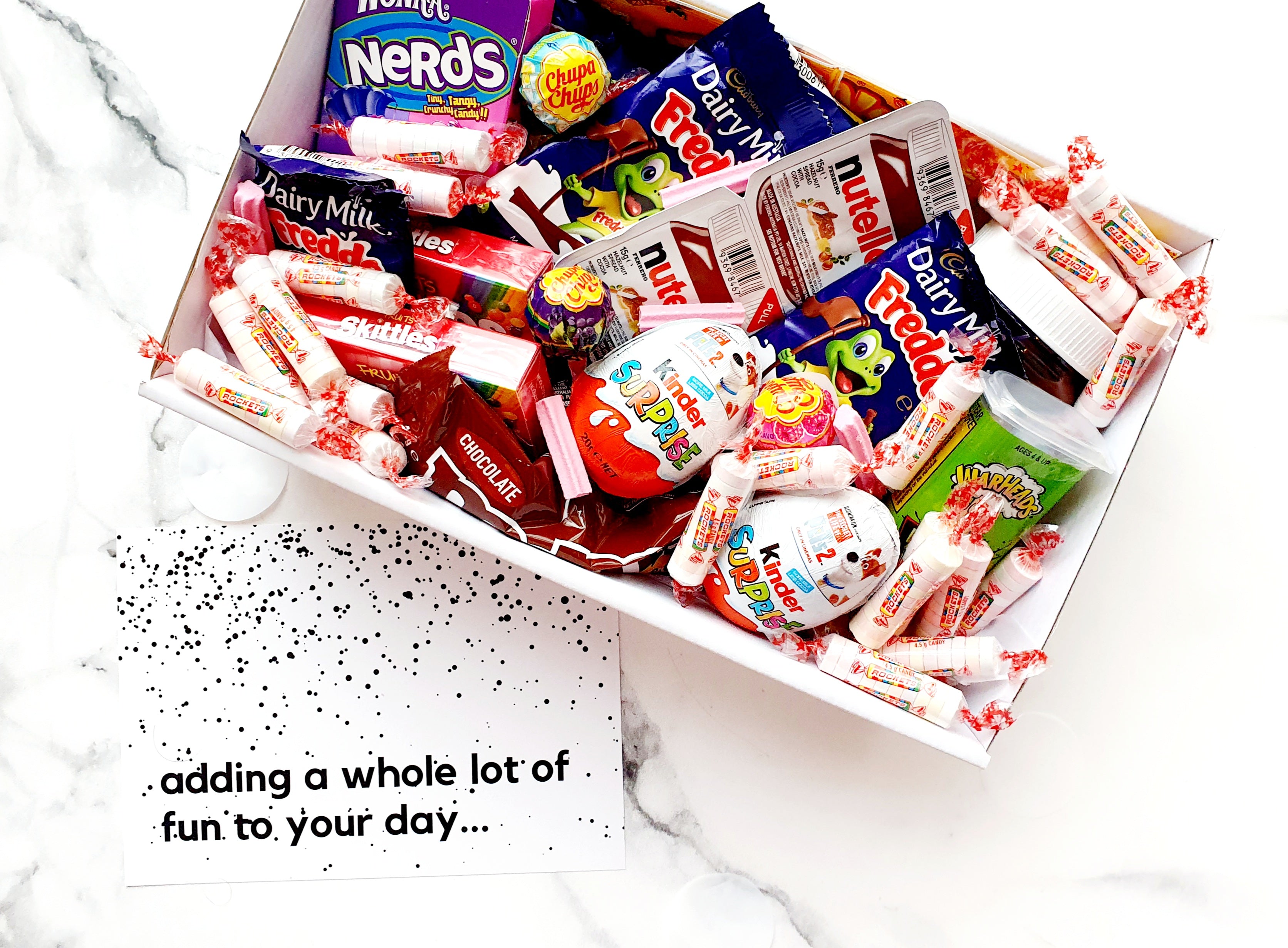 Sugar Rush snack box filled with assorted chocolates, lollies, Nutella, Kinder Surprise eggs, Skittles, Nerds, and Warheads. The perfect candy gift box for any occasion.