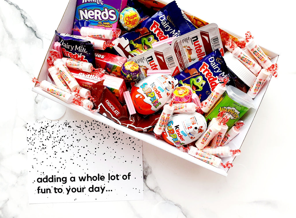 Sugar Rush snack box filled with assorted chocolates, lollies, Nutella, Kinder Surprise eggs, Skittles, Nerds, and Warheads. The perfect candy gift box for any occasion.