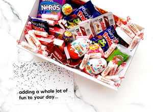 Sugar Rush snack box filled with assorted chocolates, lollies, Nutella, Kinder Surprise eggs, Skittles, Nerds, and Warheads. The perfect candy gift box for any occasion.